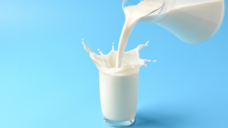 Pouring milk from pitcher into glass