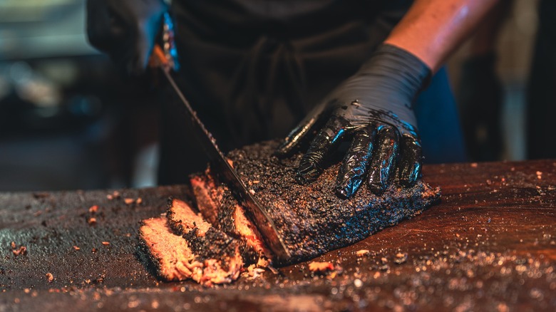 chef slicing smoked brisket