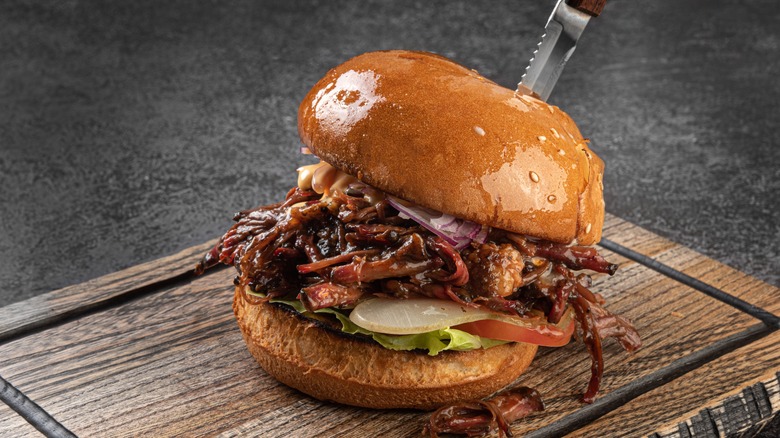 pulled pork sandwich on cutting board