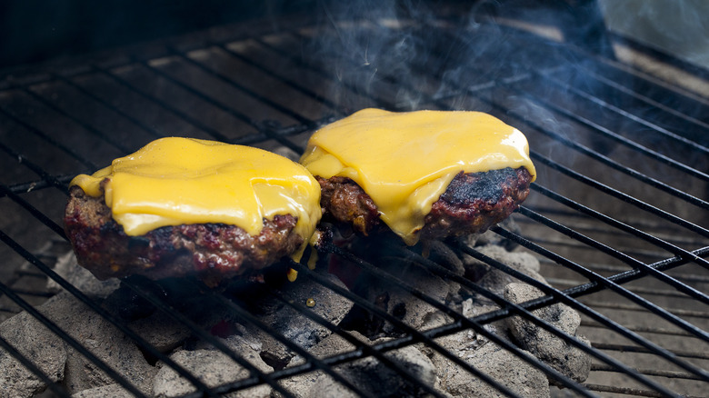 burgers with melting cheese on grill