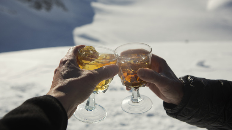 Hot toddy, cheers in winter snow