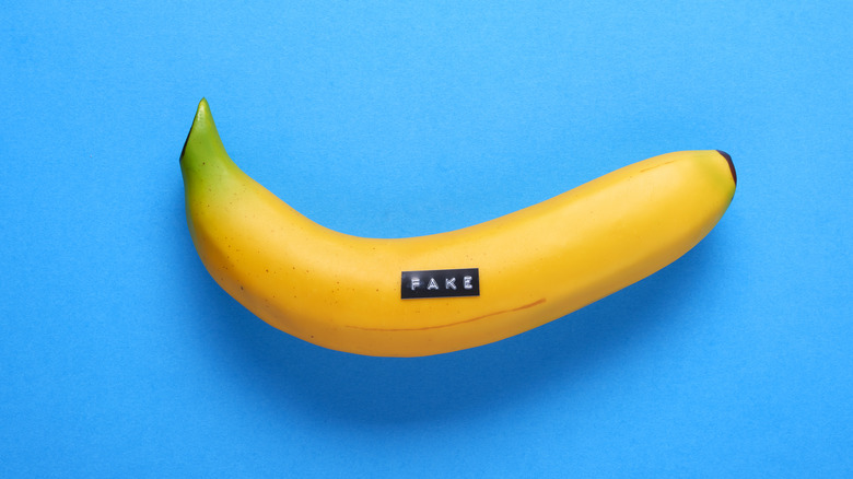 Banana on blue background labeled "fake"