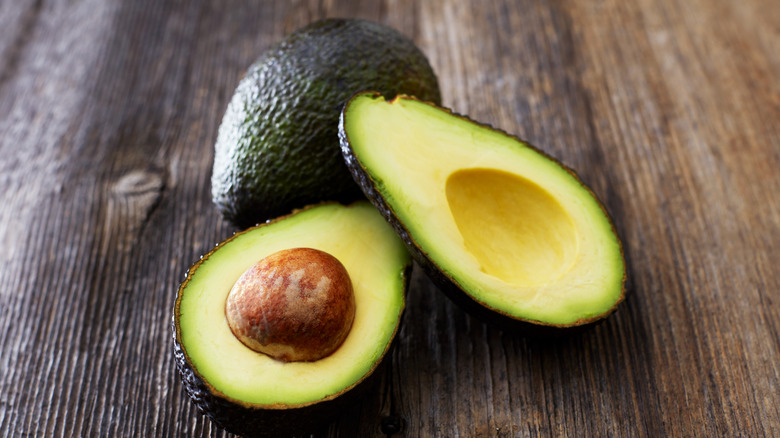 avocados on a wooden surface