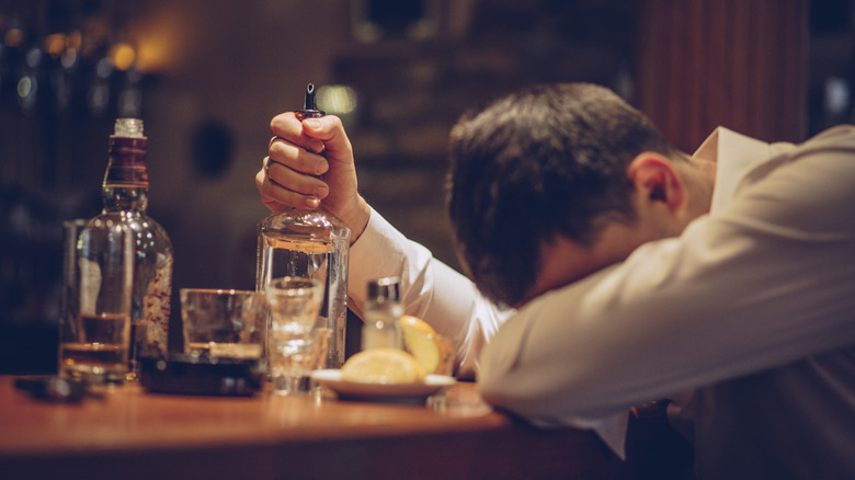 man drinking too much alcohol