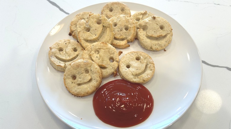 Potato smiley fries on a plate with ketchup