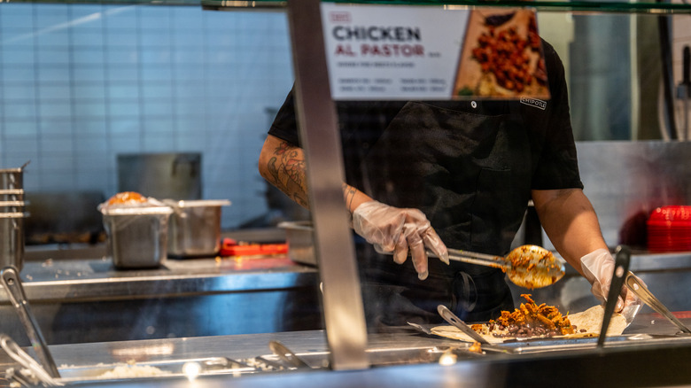 Chipotle server preparing food